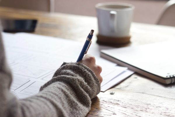 man writing on a planner