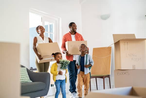 Black family with two children moving hou