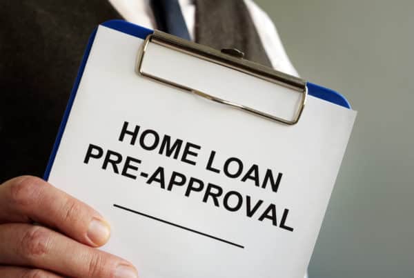 Home loan pre approval and mortgage documents in the hands.