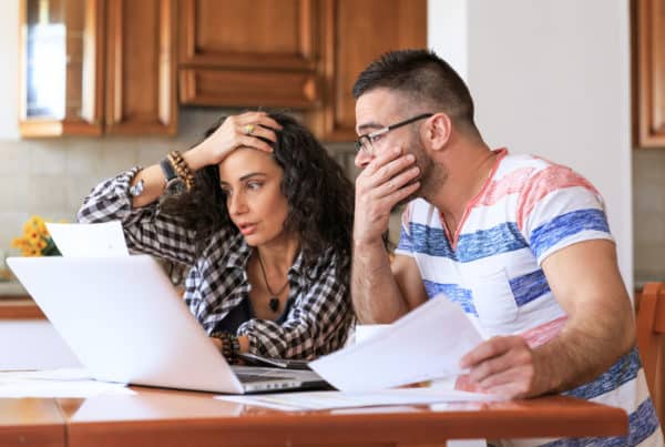 Young woman sitting at home and making home finances, with casual clothes.